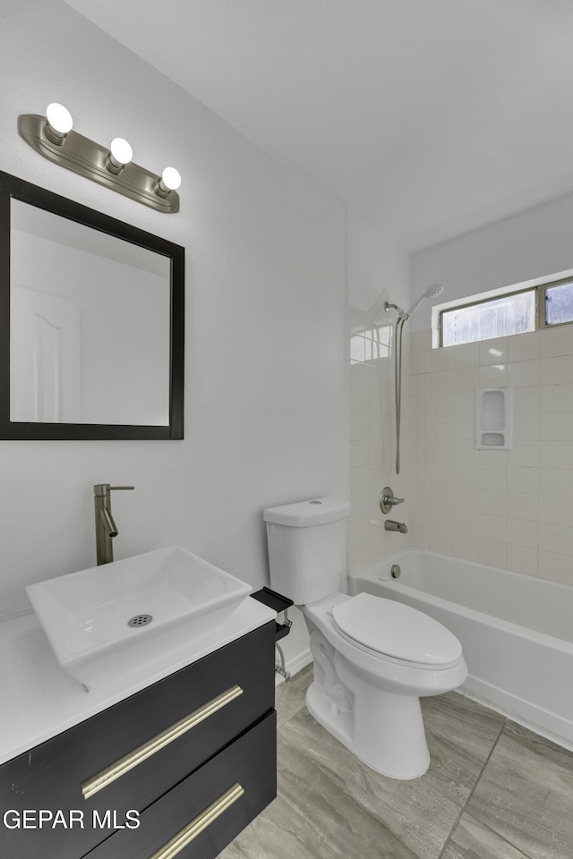 full bathroom with vanity, toilet, and tiled shower / bath