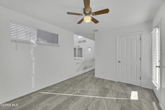 unfurnished living room featuring ceiling fan