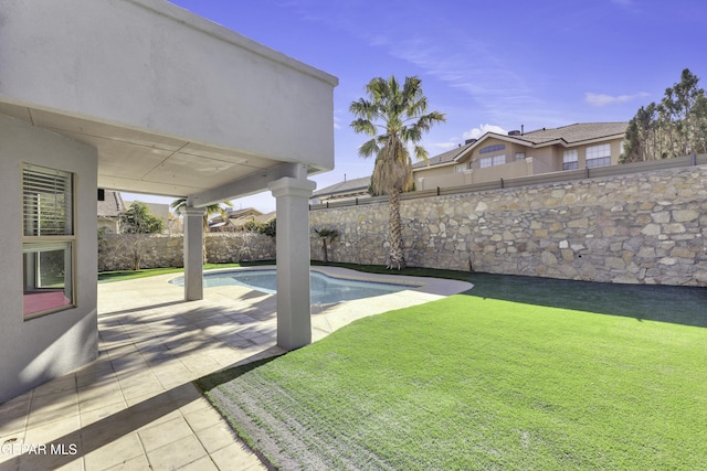 view of yard featuring a fenced in pool and a patio