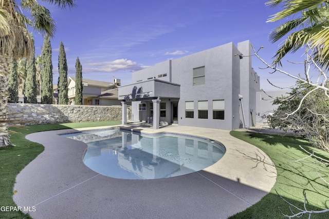 view of swimming pool with a patio area and a hot tub