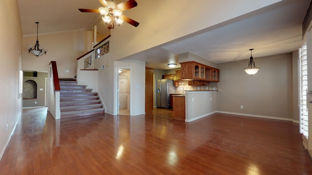 unfurnished living room featuring ceiling fan and dark hardwood / wood-style flooring