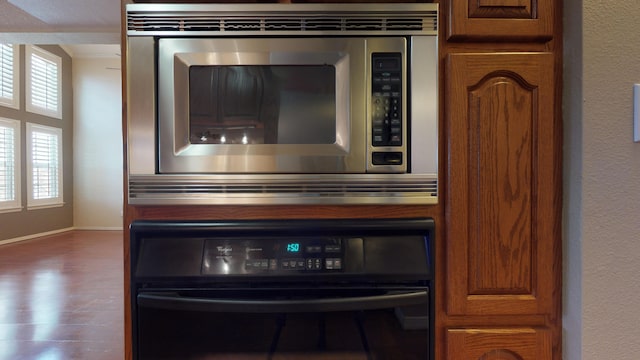 room details featuring stainless steel microwave and oven