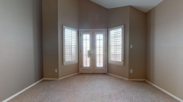 empty room featuring light carpet and french doors