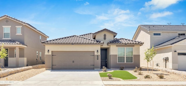 mediterranean / spanish-style home with a garage