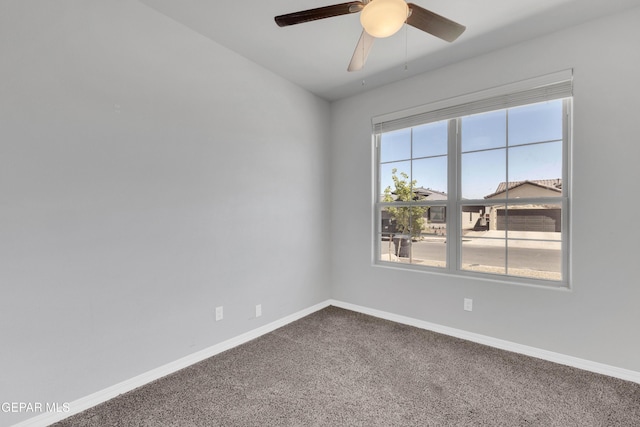 empty room featuring carpet flooring, a wealth of natural light, and ceiling fan