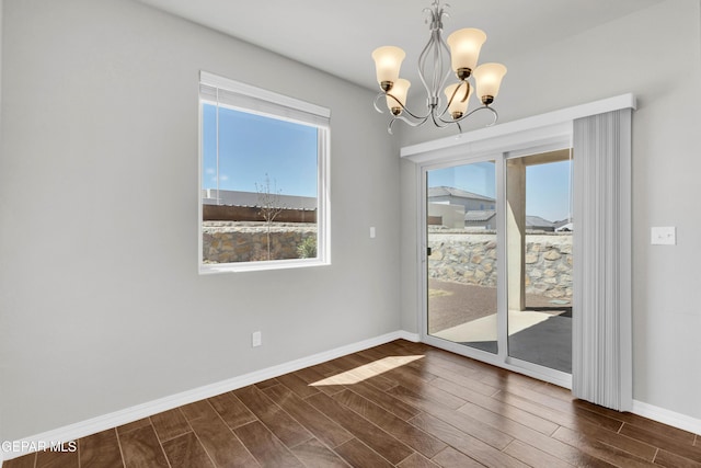 unfurnished dining area featuring an inviting chandelier