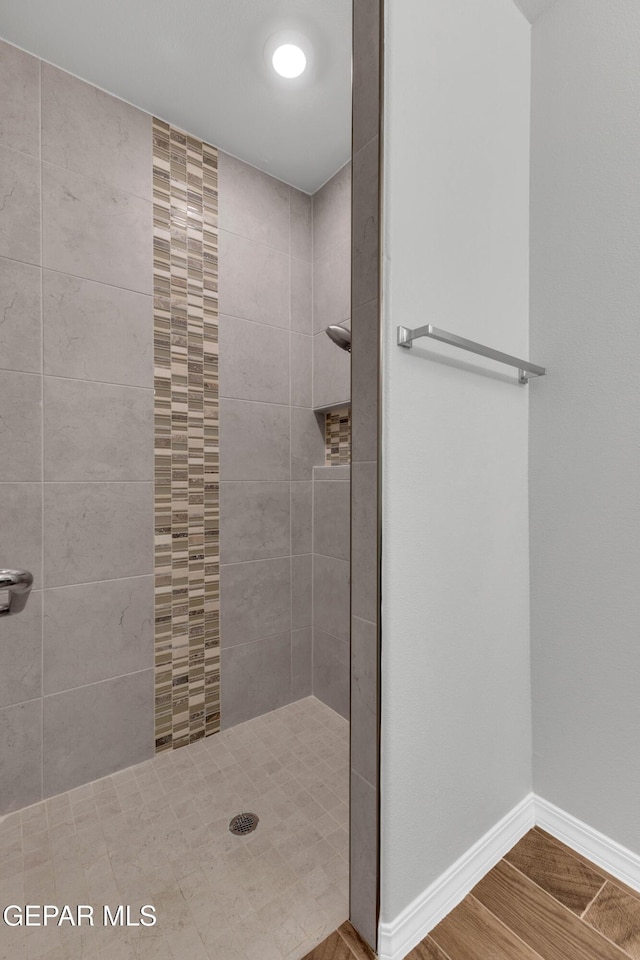 bathroom with tiled shower