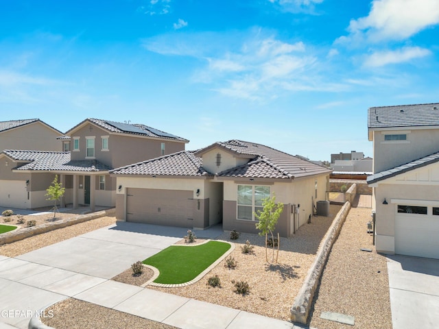 view of front of home with solar panels and a garage