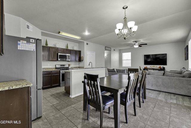 dining room with ceiling fan with notable chandelier