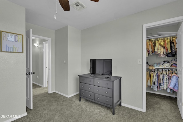 carpeted bedroom with ceiling fan and a closet