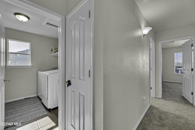 hall with washer and clothes dryer, plenty of natural light, and carpet floors