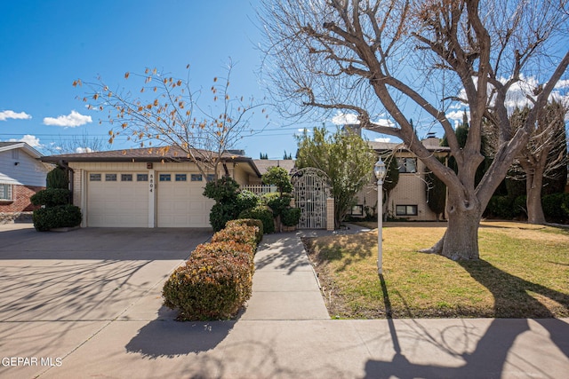 view of front of property featuring a front yard and a garage