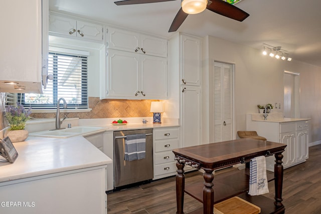 kitchen featuring sink, stainless steel dishwasher, dark hardwood / wood-style floors, tasteful backsplash, and white cabinetry