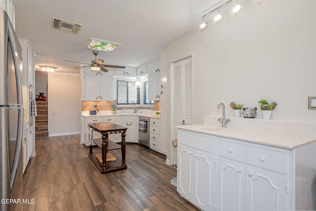 kitchen featuring white cabinets, ceiling fan, sink, and dark wood-type flooring