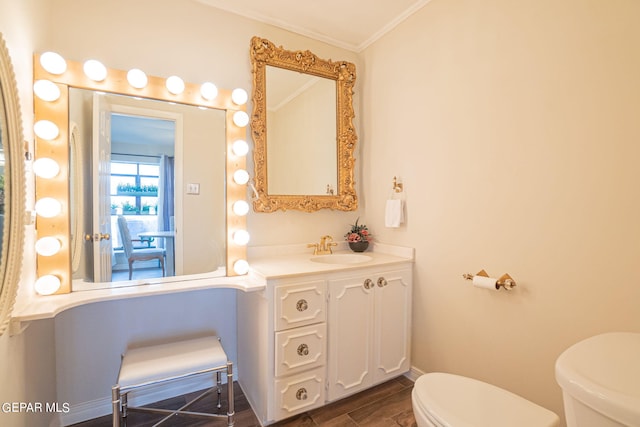 bathroom featuring crown molding, vanity, and toilet