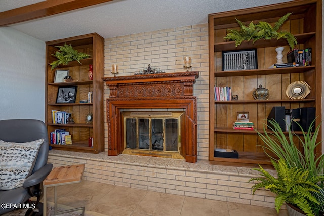 tiled living room featuring a textured ceiling and a fireplace