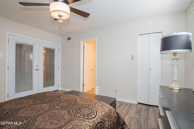 bedroom with ceiling fan, french doors, and wood-type flooring