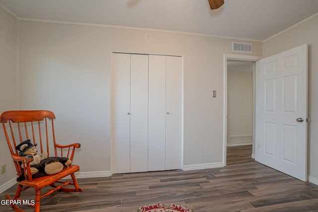 living area with dark hardwood / wood-style flooring, ceiling fan, and ornamental molding