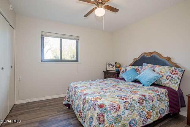 bedroom with ceiling fan, dark hardwood / wood-style flooring, and a closet