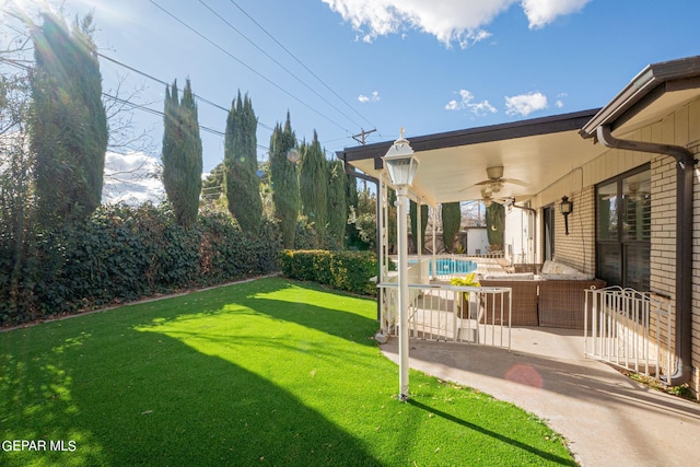 view of yard with a patio and ceiling fan