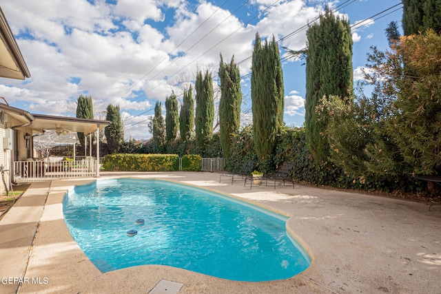 view of pool with ceiling fan and a patio area