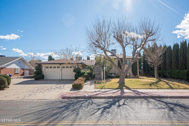 view of front of home featuring a front yard and a garage