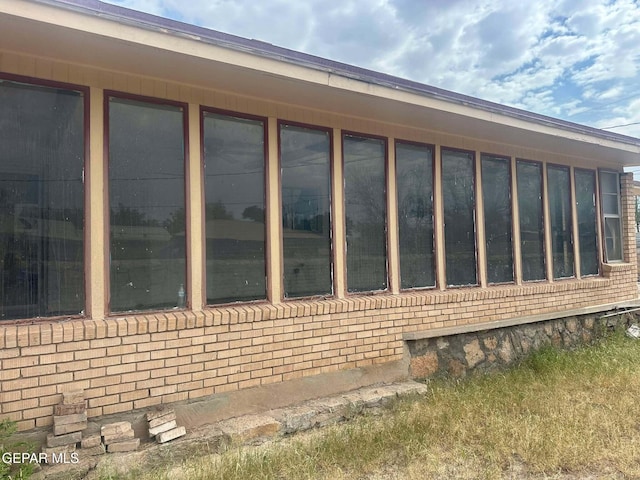 view of side of property with a sunroom