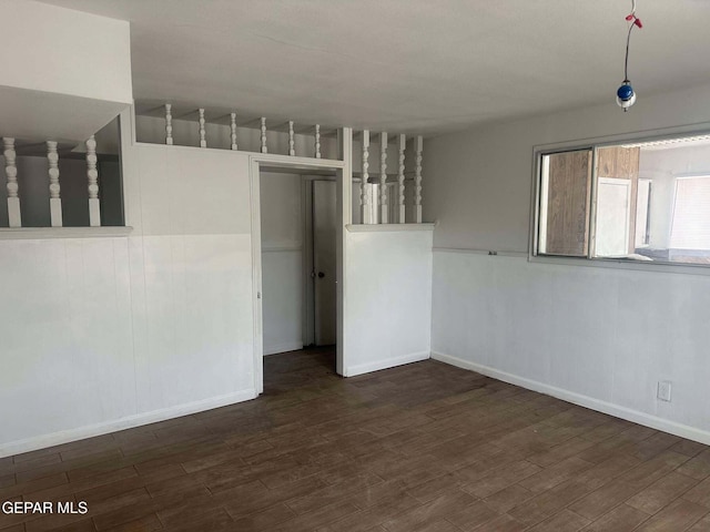 empty room with dark wood-type flooring