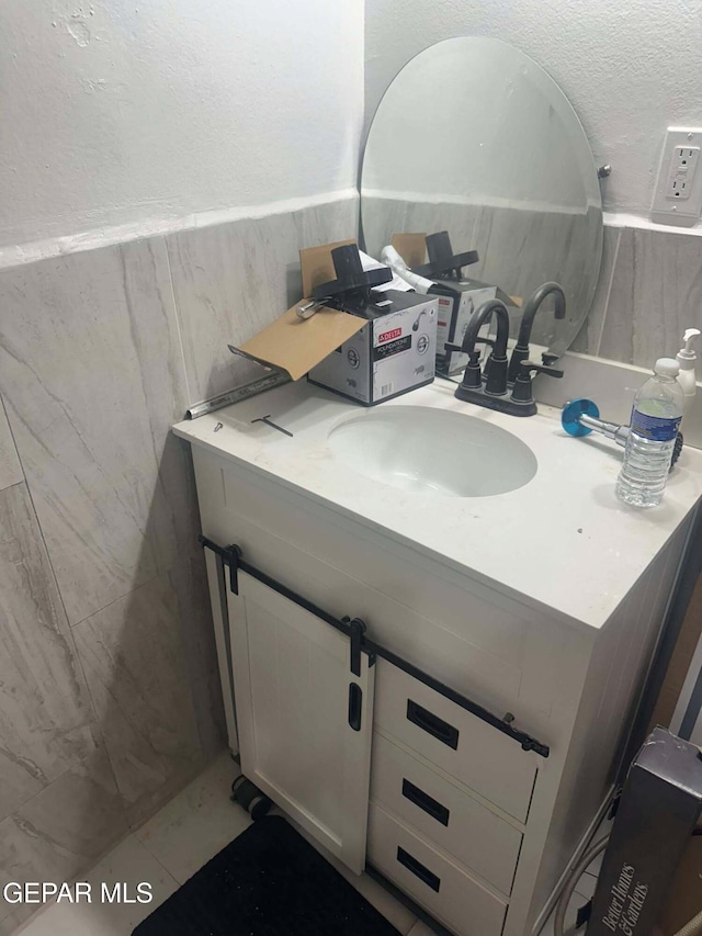 bathroom featuring tile patterned flooring and vanity