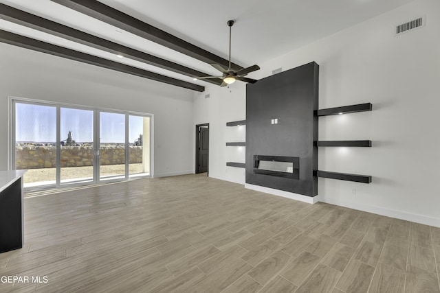 1762 Green Valley St, El Paso, TX 79928 - unfurnished living room featuring a fireplace, ceiling fan, beam ceiling, baseboards, and light wood-style floors