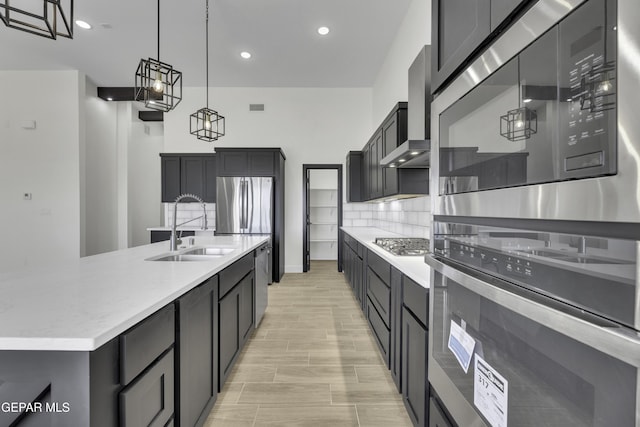 1762 Green Valley St, El Paso, TX 79928 - kitchen featuring a sink, appliances with stainless steel finishes, hanging light fixtures, wall chimney exhaust hood, and a large island