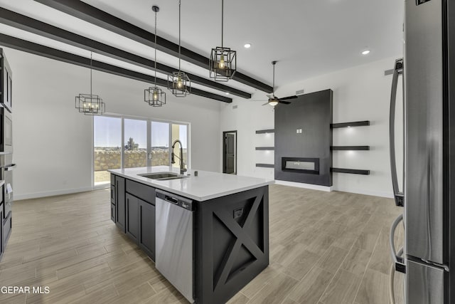 1762 Green Valley St, El Paso, TX 79928 - kitchen with appliances with stainless steel finishes, a sink, a ceiling fan, beamed ceiling, and light countertops