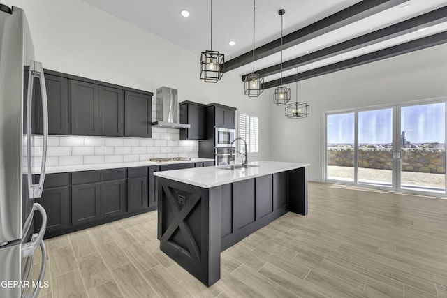 1762 Green Valley St, El Paso, TX 79928 - kitchen featuring wall chimney exhaust hood, stainless steel appliances, light countertops, a sink, and beam ceiling