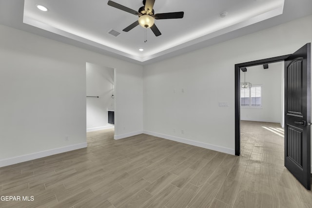 1762 Green Valley St, El Paso, TX 79928 - unfurnished room with a raised ceiling, ceiling fan, baseboards, light wood-style floors, and recessed lighting