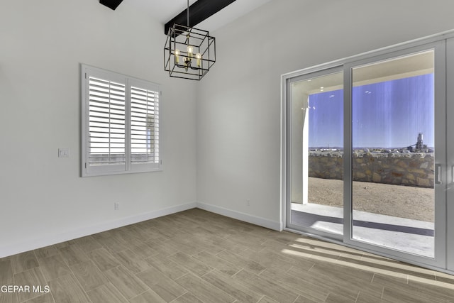 1762 Green Valley St, El Paso, TX 79928 - unfurnished dining area featuring a chandelier, baseboards, and a high ceiling