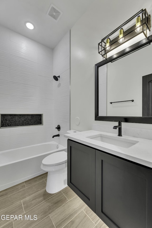 1762 Green Valley St, El Paso, TX 79928 - full bath featuring vanity, toilet, bathing tub / shower combination, and wood tiled floors