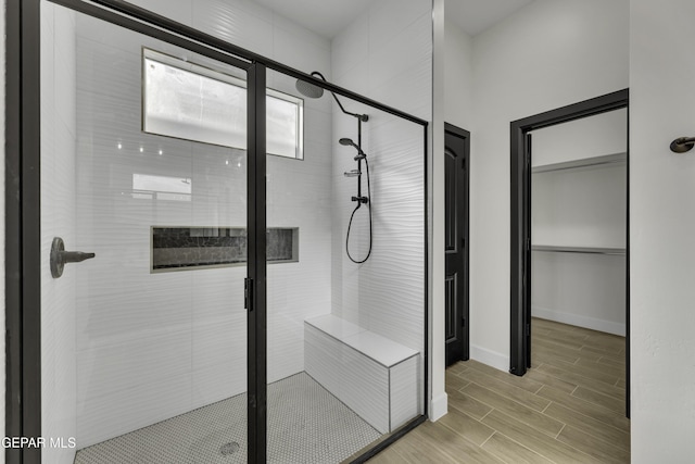 1762 Green Valley St, El Paso, TX 79928 - bathroom with a stall shower, wood tiled floors, a closet, and baseboards