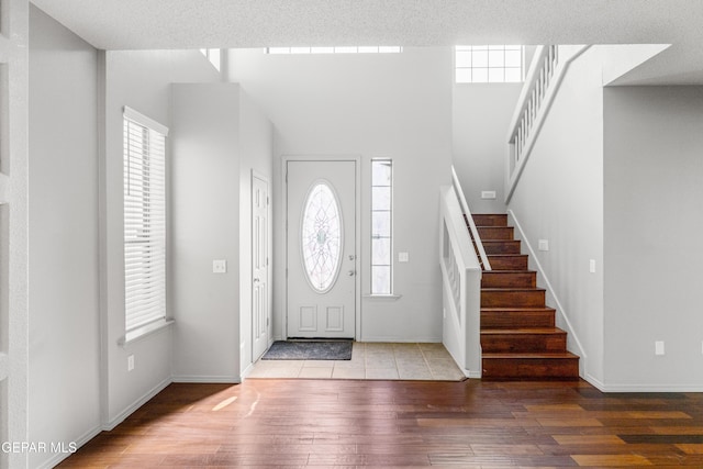 entryway with a textured ceiling and light wood-type flooring