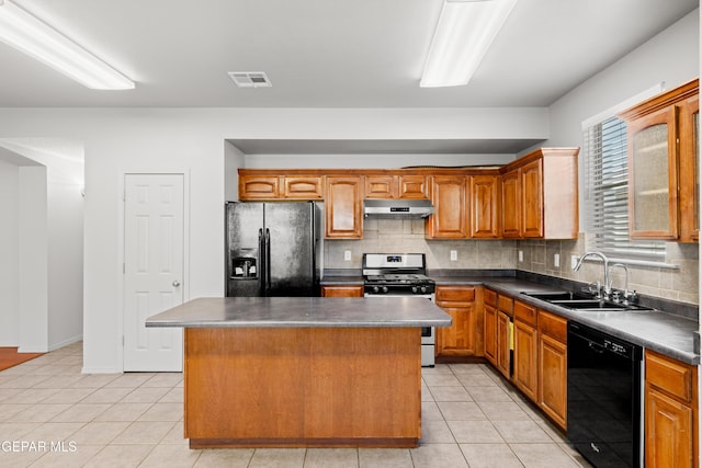 kitchen with sink, backsplash, light tile patterned floors, a kitchen island, and black appliances