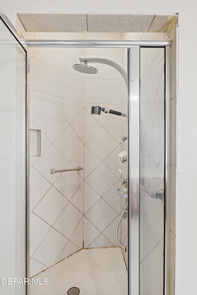 bathroom with a shower with shower door