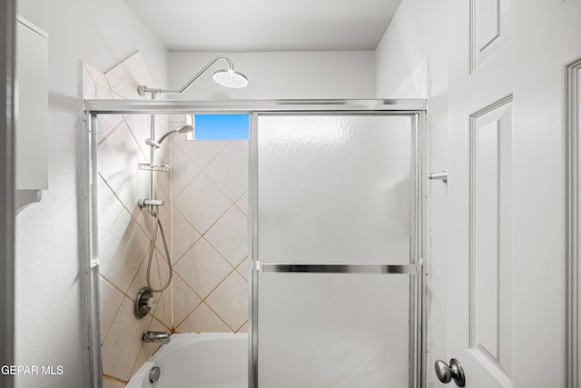 bathroom with shower / bath combination with glass door