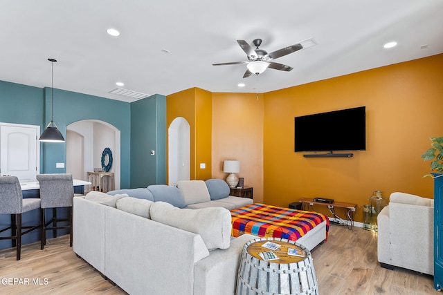 living room featuring ceiling fan and light hardwood / wood-style floors