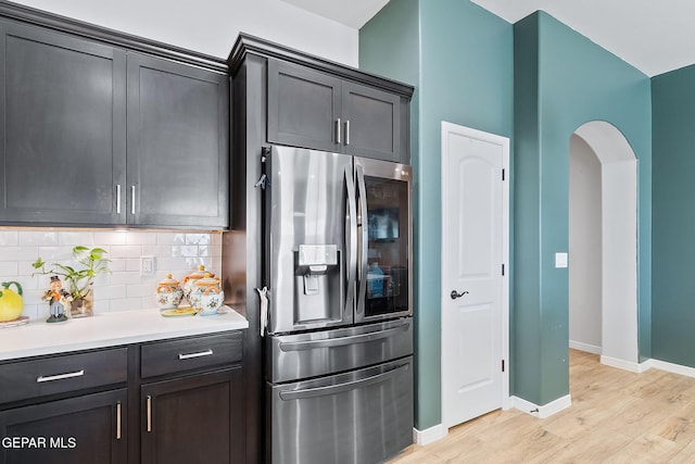 kitchen featuring tasteful backsplash, light hardwood / wood-style flooring, and stainless steel refrigerator with ice dispenser