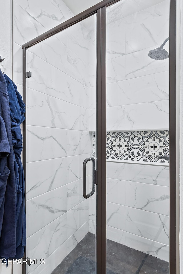 details with a shower with door