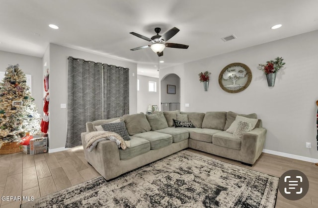 living room with hardwood / wood-style flooring and ceiling fan