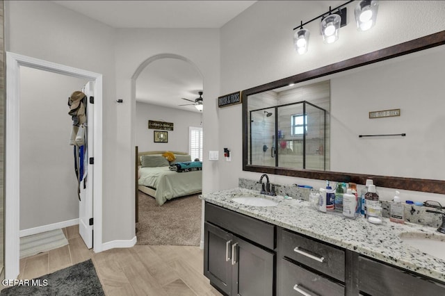 bathroom featuring vanity, ceiling fan, and a shower with shower door