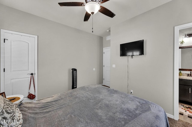 bedroom featuring carpet, sink, connected bathroom, and ceiling fan