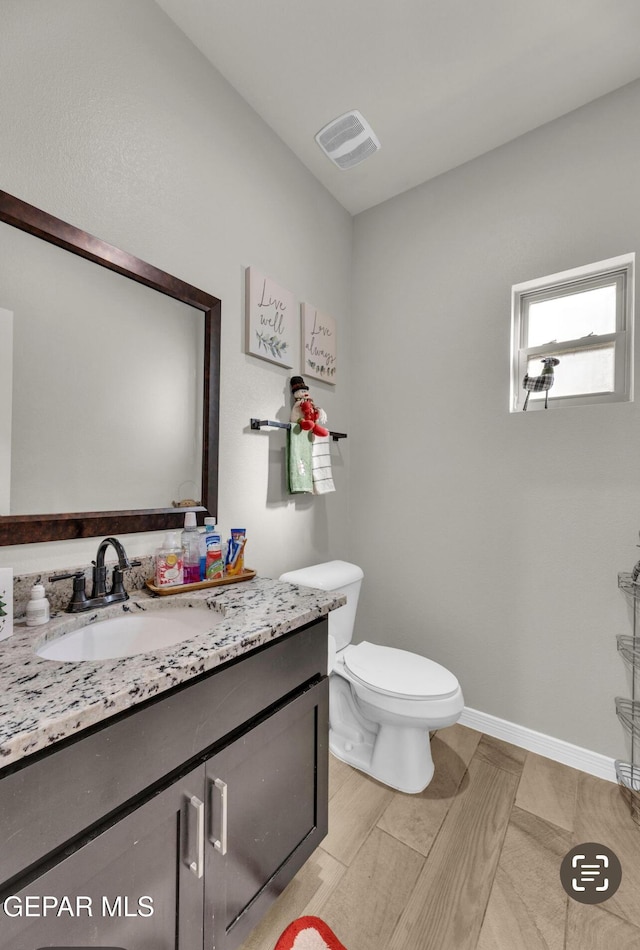 bathroom with vanity and toilet