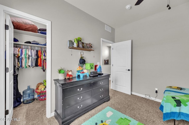 bedroom featuring light colored carpet, a closet, and ceiling fan