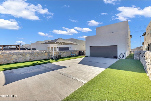 view of front of property featuring a garage and a front yard